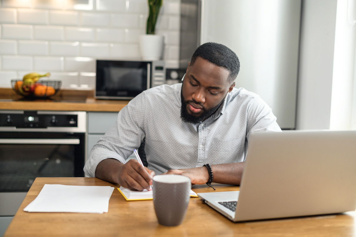African American man studying online from home